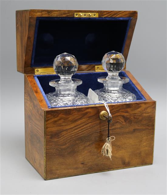 A walnut cased pair of cut glass decanters
